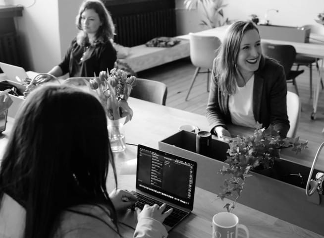 group of women around a desk